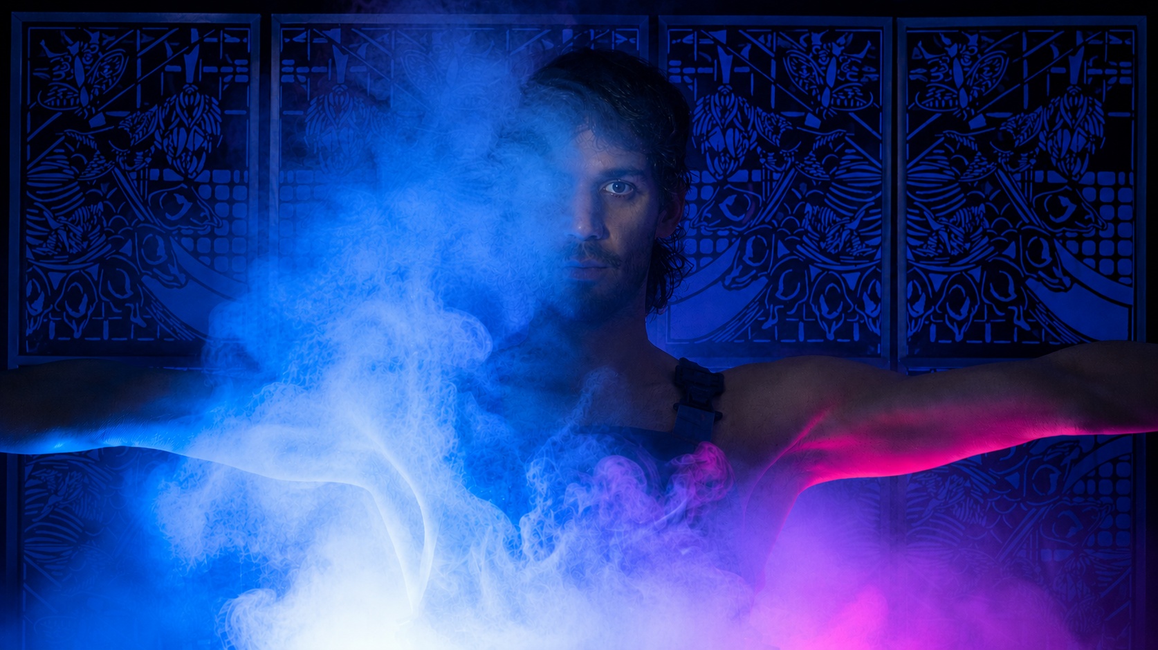 Portrait of a participant standing with outstretched arms before the FableType light-cutting installation. Blue and magenta lighting and drifting fog partially veil the figure, creating a dramatic fine art portrait.
