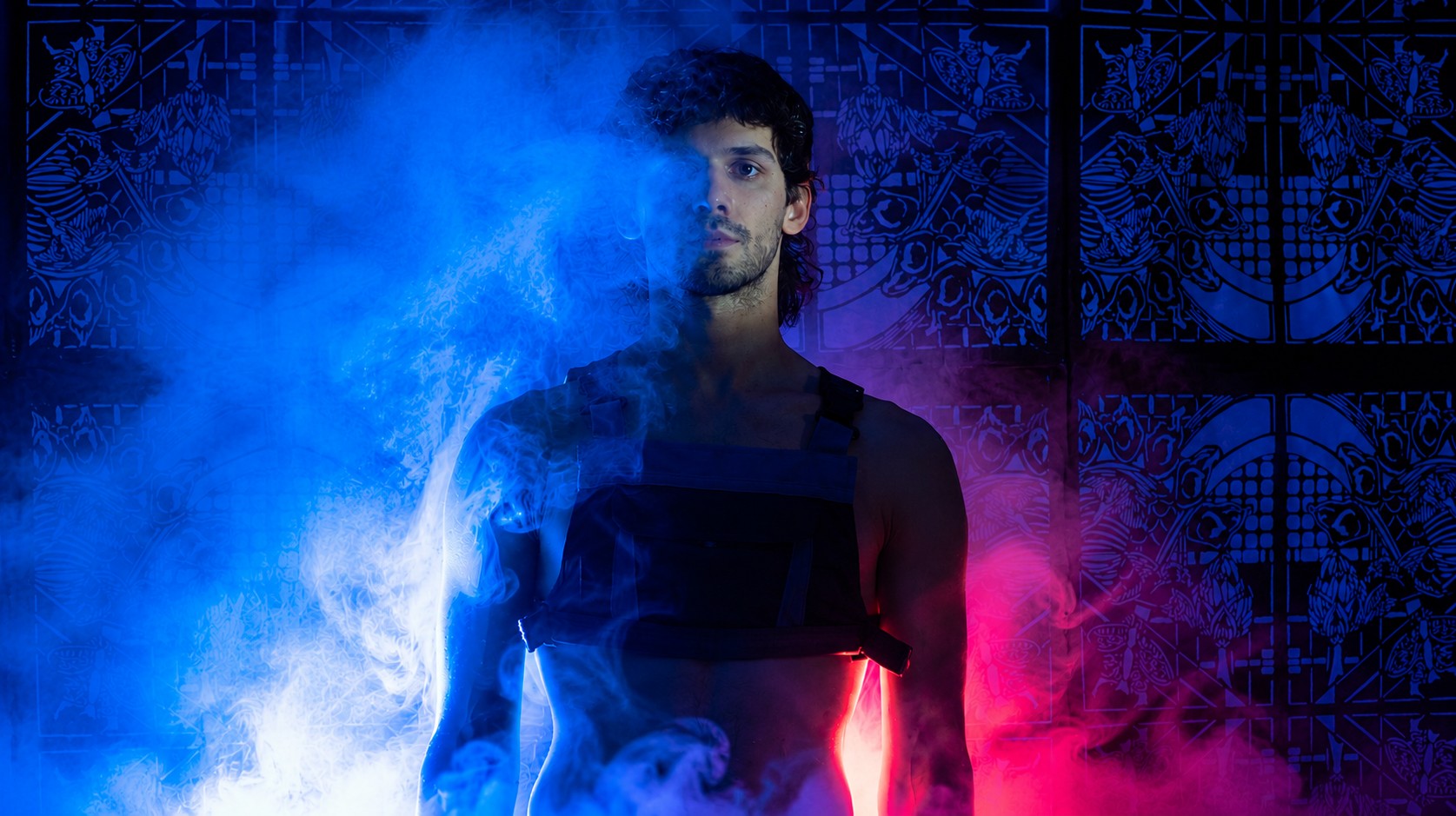 Portrait of a participant standing before the FableType light-cutting installation as illuminated blue and magenta fog surrounds the body, creating an immersive fine art portrait.
