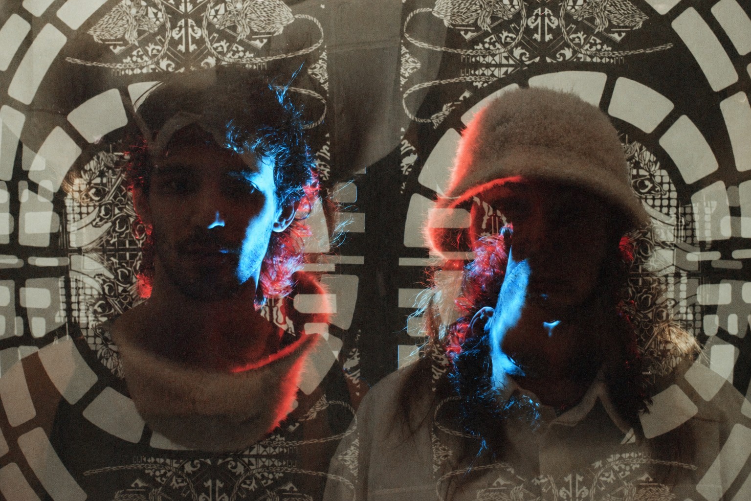 Double-exposure analogue portrait of two participants before the FableType light-cutting installation, layering coloured light, portraiture and illuminated paper artwork.
