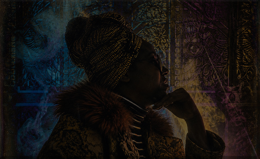 Profile portrait of a participant before the FableType light-cutting installation, illuminated by blue, amber and magenta lighting with drifting fog, creating a contemplative fine art portrait.
